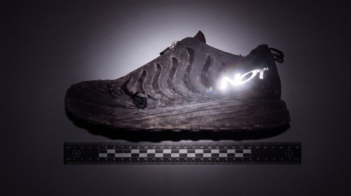 Worn black NR1 with an illuminated NOT logo above a measurement scale